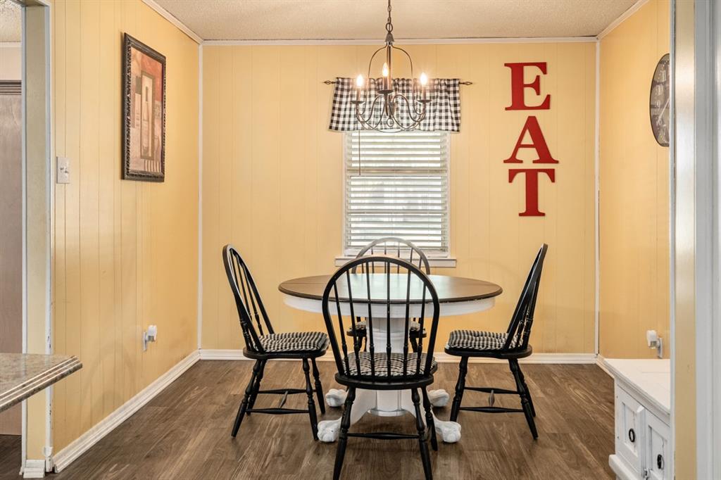 508 West 9th Street Kemp, TX 75143 - Photo 7 of 32 a view of a dining room with furniture wooden floor and a chandelier