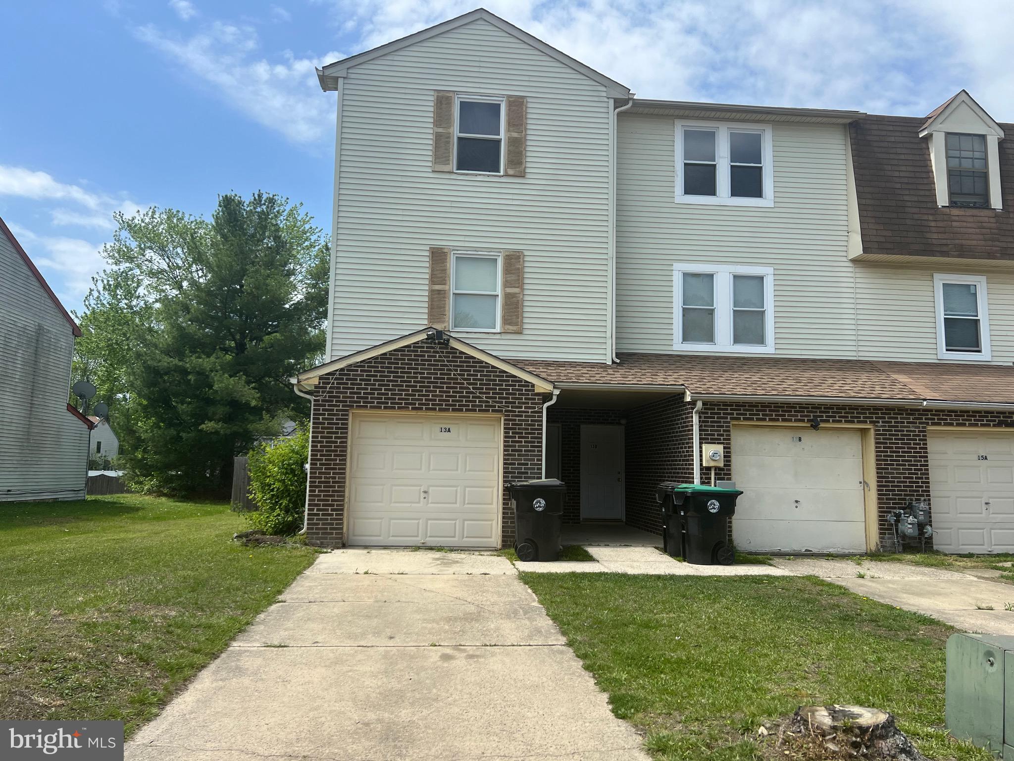 13 A Hampton Gate Drive Sicklerville, NJ 08081 - Photo 21 of 23 a front view of a house with a yard and a garage