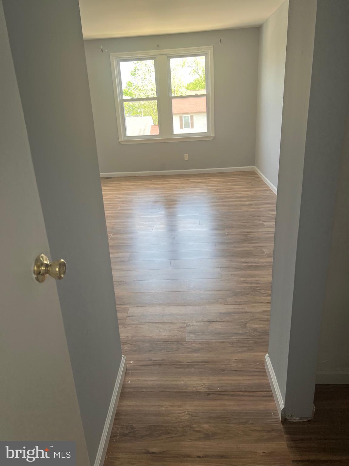 13 A Hampton Gate Drive Sicklerville, NJ 08081 - Photo 22 of 23 a view of an empty room with wooden floor and a window