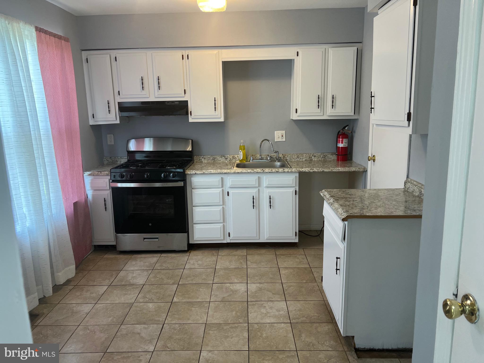 13 A Hampton Gate Drive Sicklerville, NJ 08081 - Photo 5 of 23 a kitchen with granite countertop a stove sink and cabinets