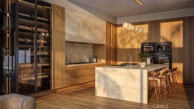 a living room with stainless steel appliances furniture a large window and a kitchen view