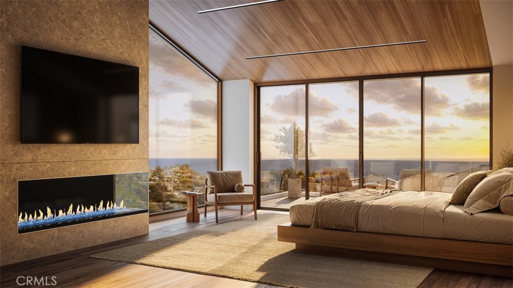 928 Emerald Bay Laguna Beach, CA 92651 - Photo 6 of 8 a living room with couches tv and a fireplace