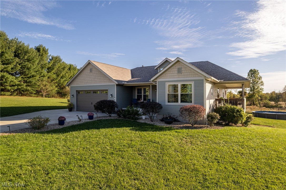 7680 Vandemark Road Lodi, OH 44254 - Photo 1 of 1 View of front of property featuring a front lawn, driveway, an attached garage, and roof with shingles