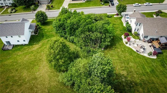 an aerial view of a house with swimming pool and garden