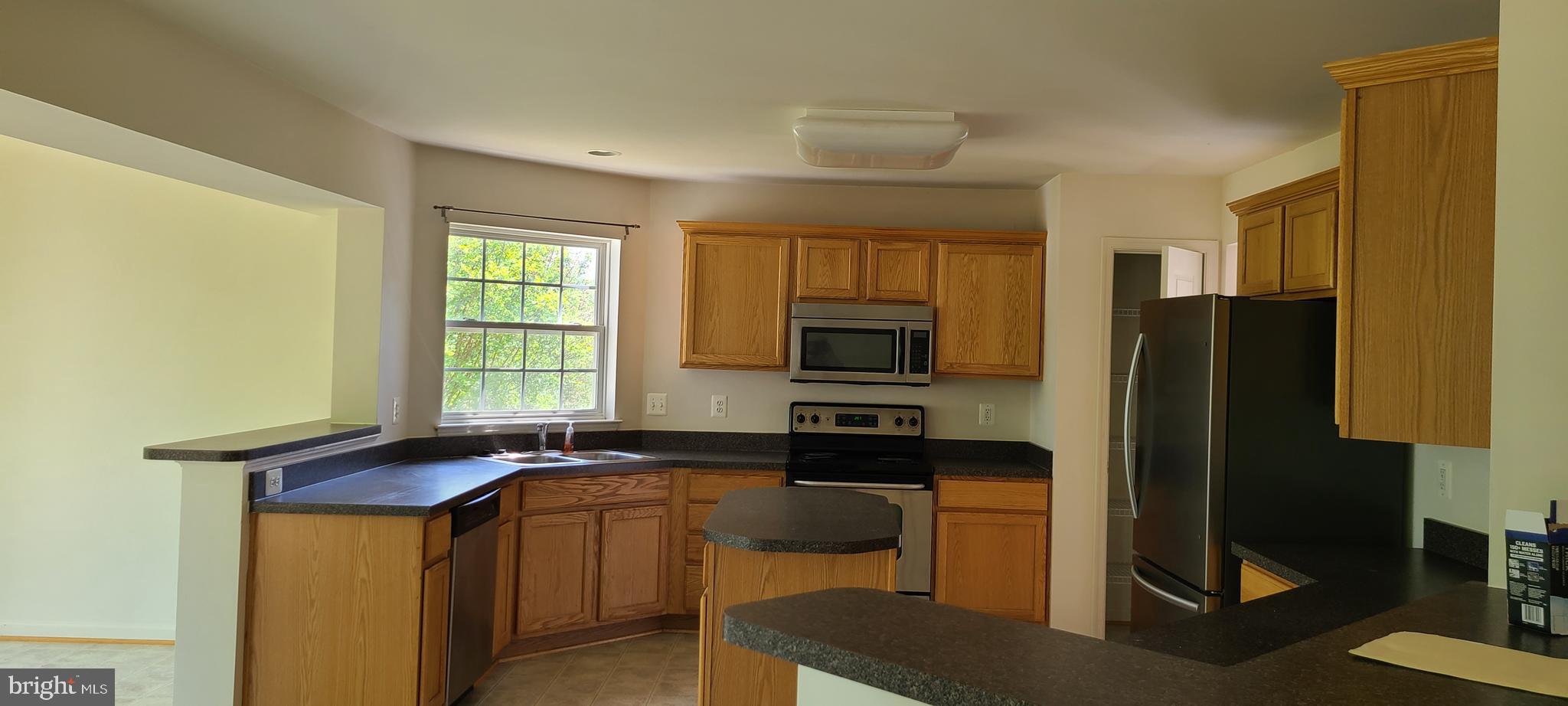 1028 Riverdale Circle Culpeper, VA 22701 - Photo 9 of 32 a kitchen with a sink a counter appliances and cabinets