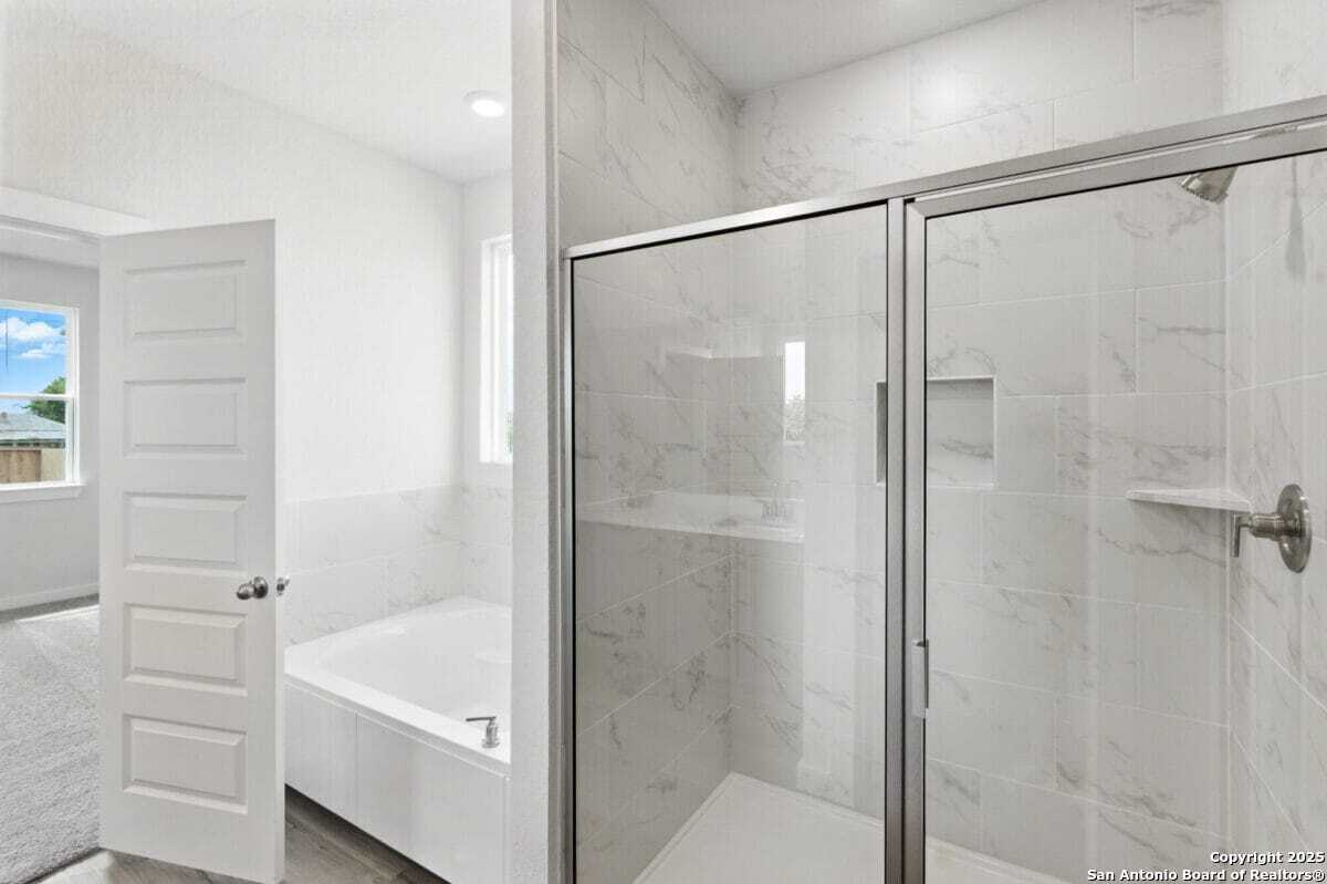 1896 Split Rock Road New Braunfels, TX 78130 - Photo 14 of 22 a bathroom with a shower and a bath tub