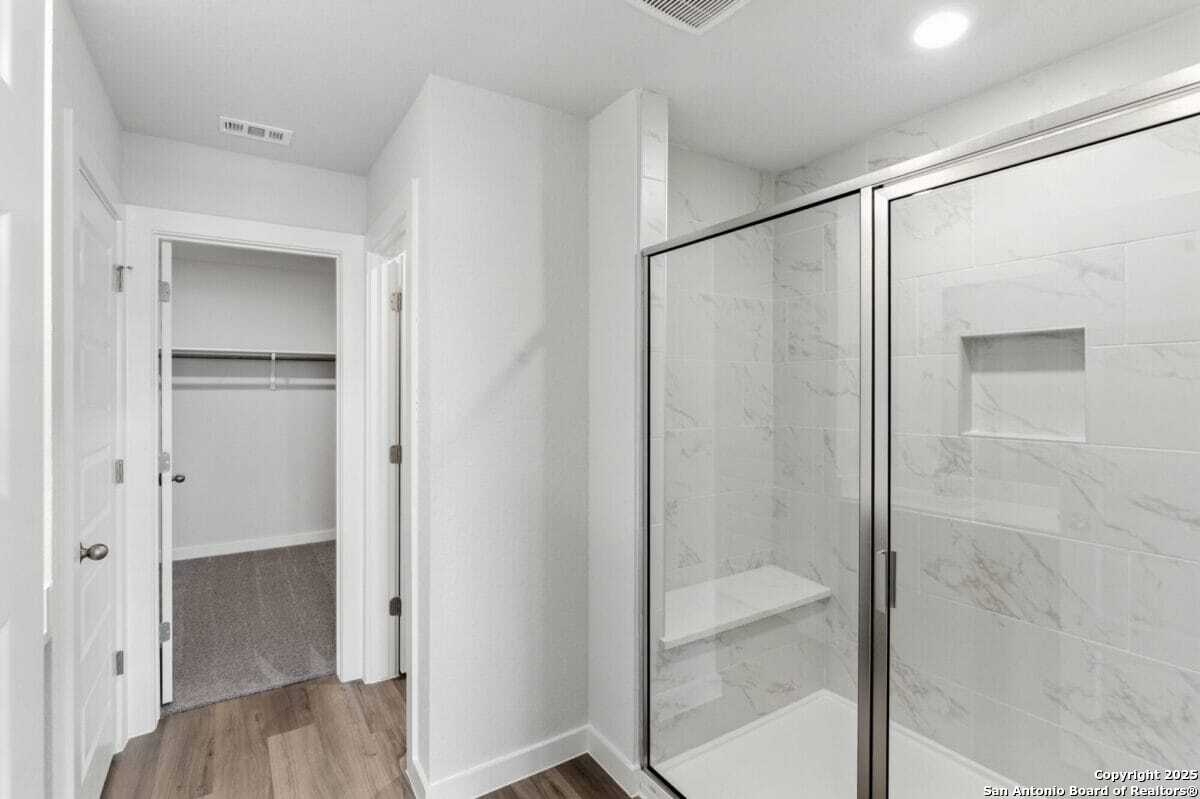 1896 Split Rock Road New Braunfels, TX 78130 - Photo 17 of 22 a bathroom with a glass shower door