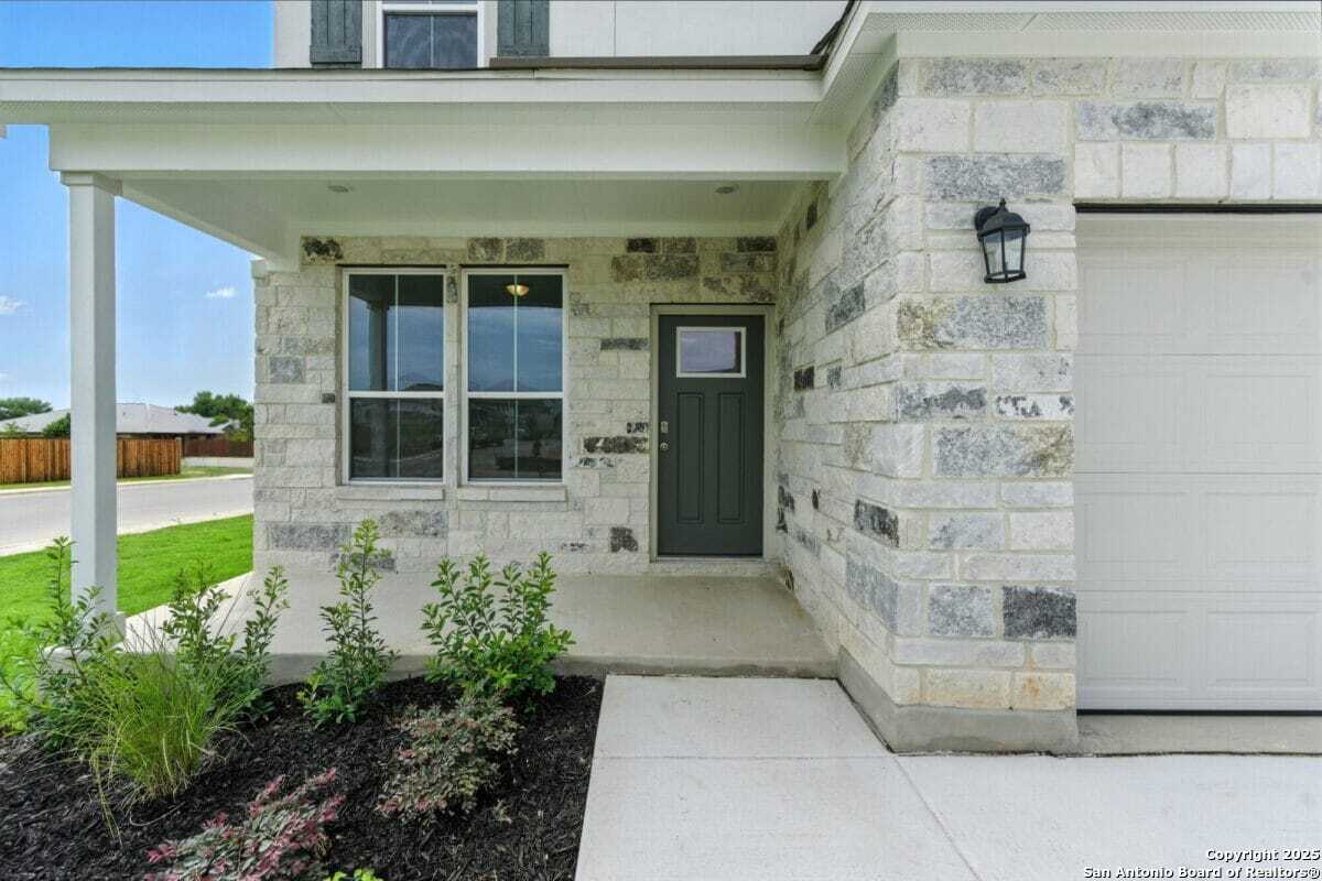 1896 Split Rock Road New Braunfels, TX 78130 - Photo 2 of 22 a front view of a house with a garden