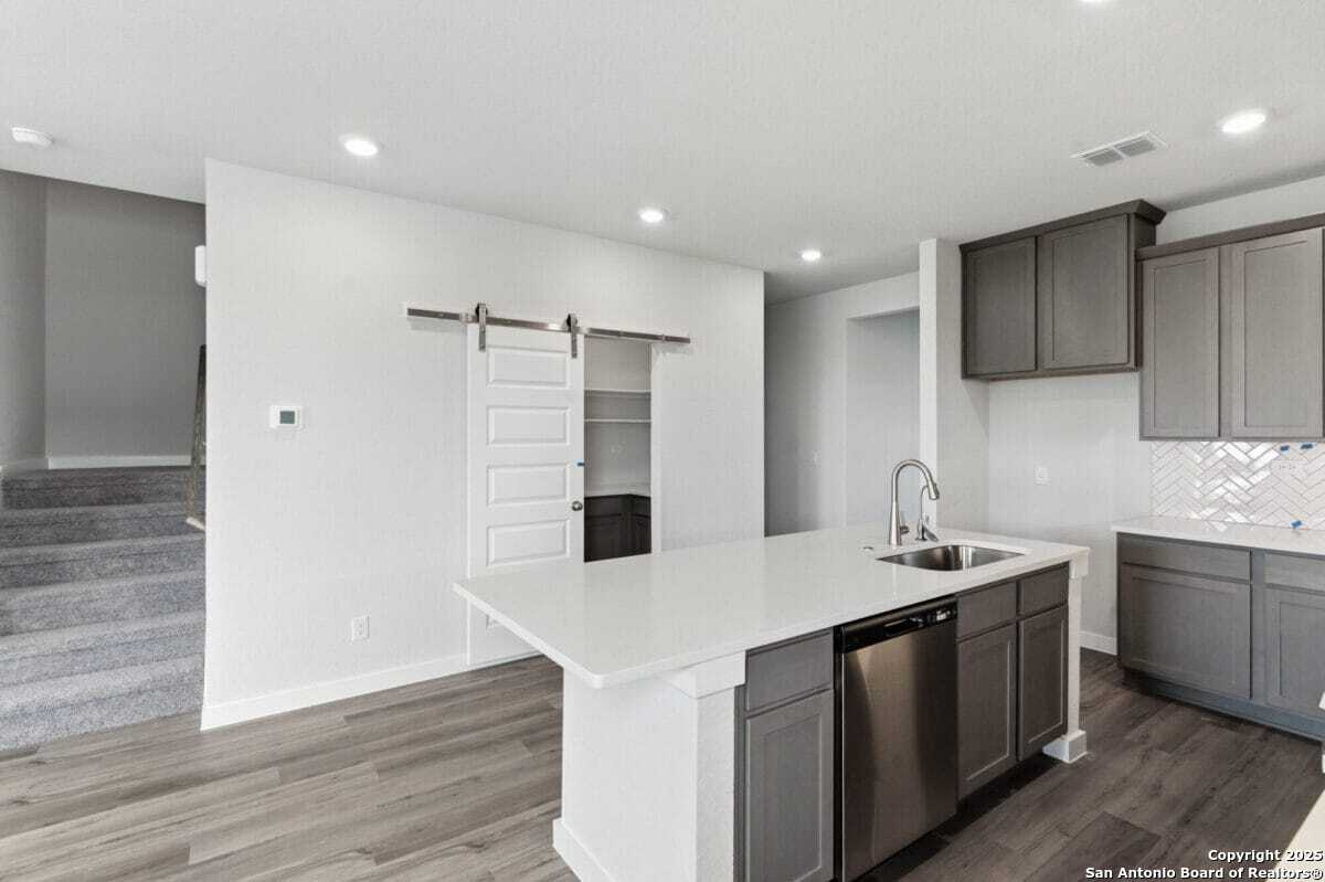 1896 Split Rock Road New Braunfels, TX 78130 - Photo 6 of 22 a kitchen with a sink stainless steel appliances and cabinets