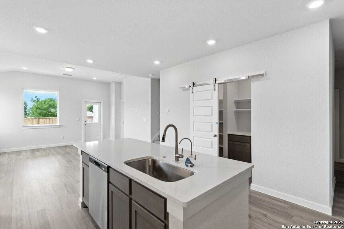 1896 Split Rock Road New Braunfels, TX 78130 - Photo 7 of 22 a kitchen with a sink and a microwave