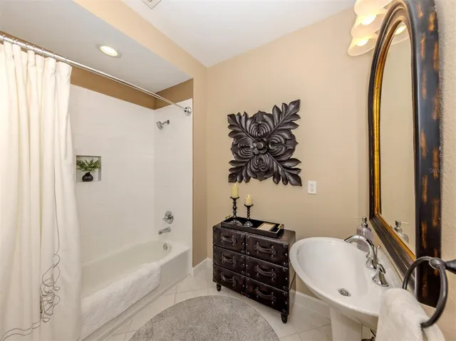 a room with lots of flower plants and wooden floor