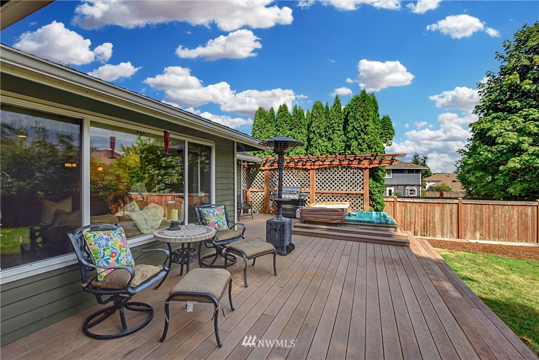 23901 23rd Drive Southeast Bothell, WA 98021 - Photo 26 of 27 a view of a patio with table and chairs with wooden floor and fence