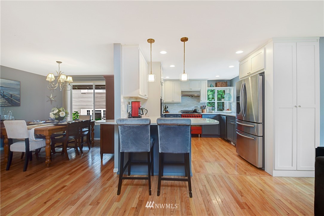 23901 23rd Drive Southeast Bothell, WA 98021 - Photo 8 of 27 a living room with stainless steel appliances kitchen island granite countertop furniture wooden floor and a kitchen view