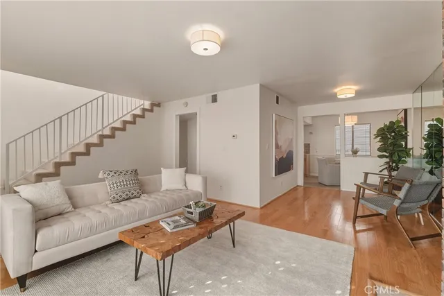 a living room with furniture and wooden floor