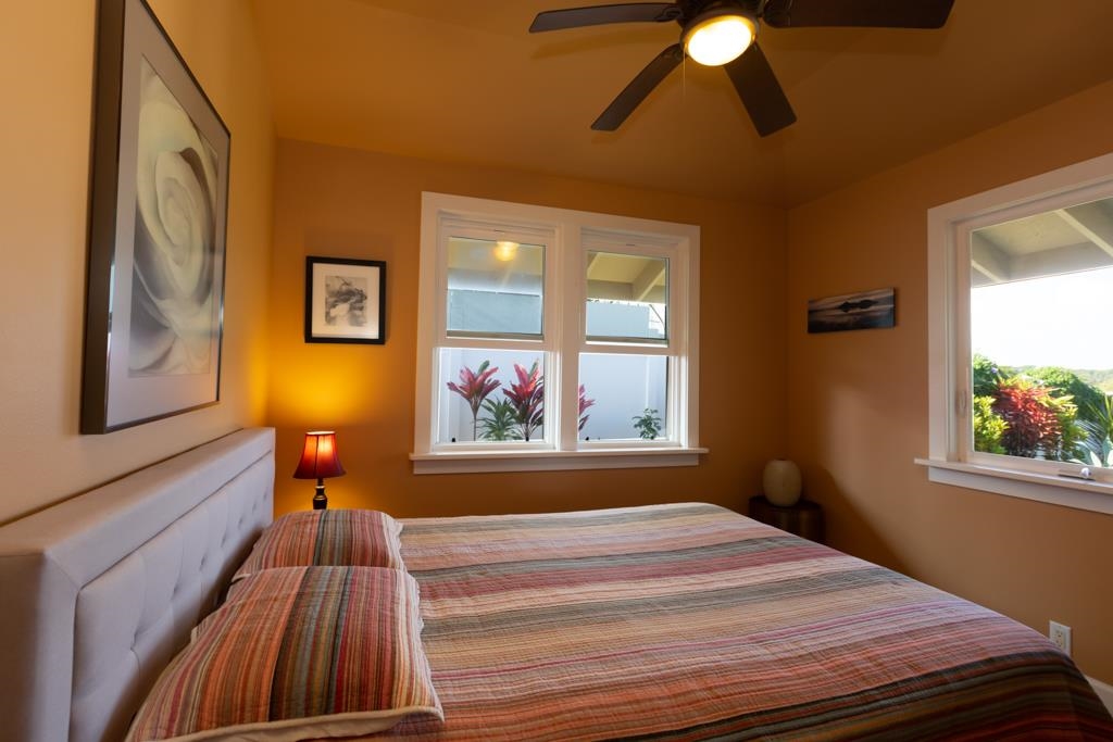 130 North Honokala Road Haiku, HI 96708 - Photo 23 of 30 a bedroom with a bed and a painting on the wall