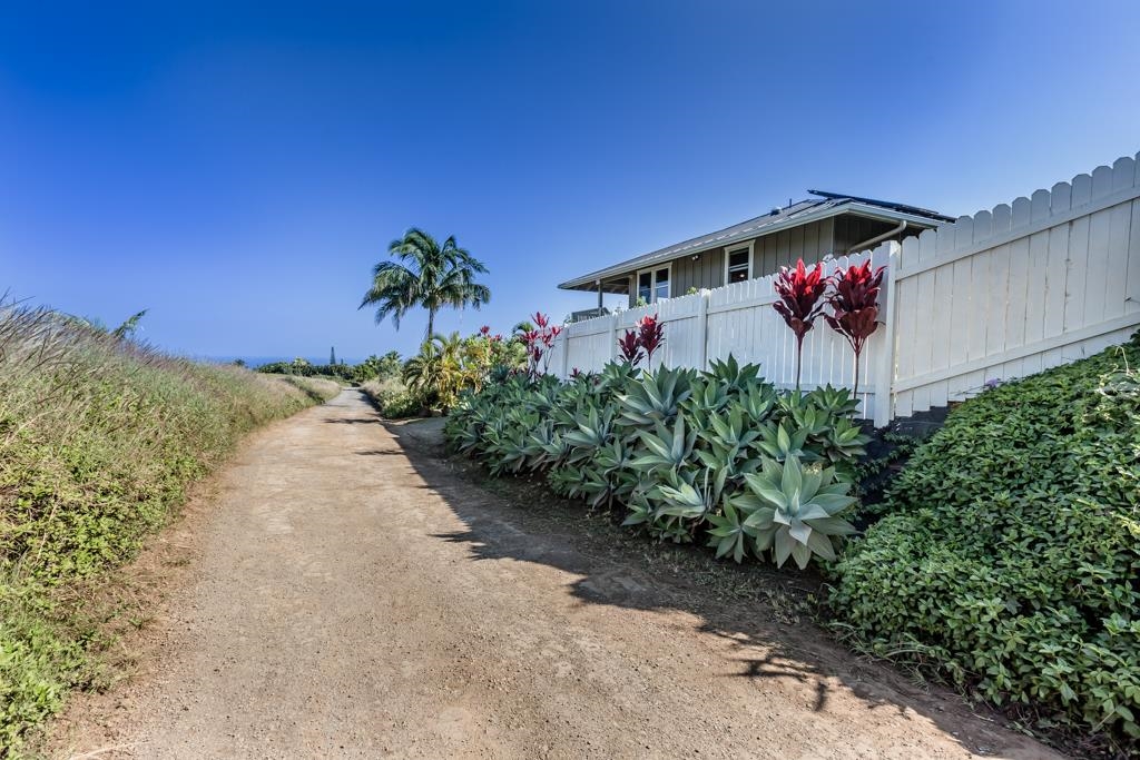 130 North Honokala Road Haiku, HI 96708 - Photo 7 of 30 a bath room with a yard and a wooden fence