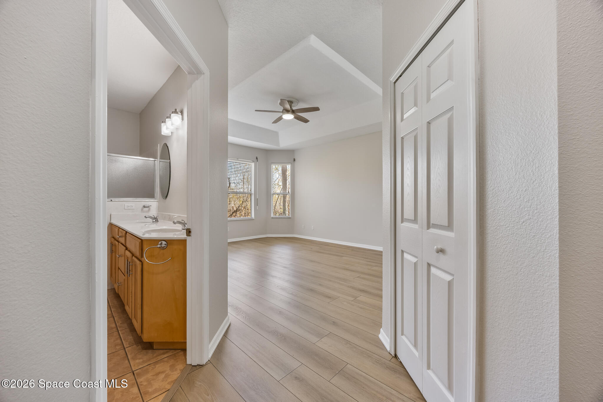 Undisclosed Address Melbourne, FL 32940 - Photo 12 of 26 a view of a hallway with wooden floor and a bathroom