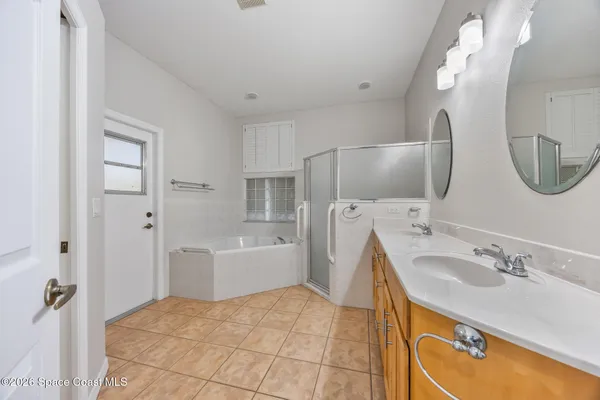 a spacious bathroom with a sink double vanity and a mirror