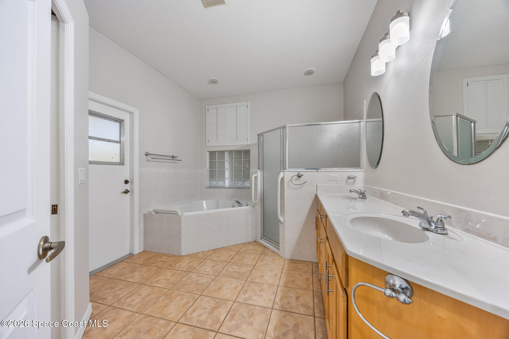 Undisclosed Address Melbourne, FL 32940 - Photo 13 of 26 a spacious bathroom with a sink double vanity and a mirror