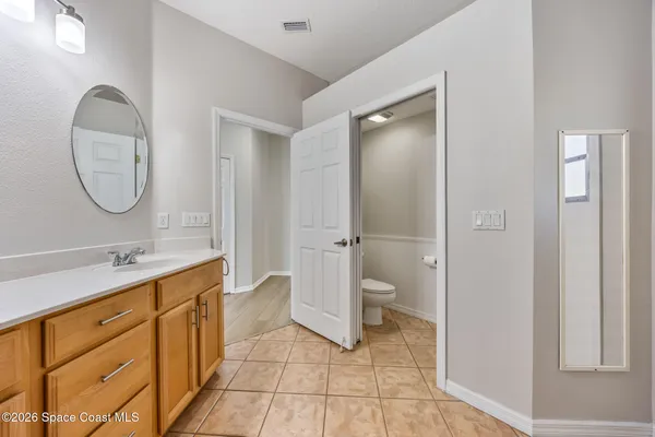a spacious bathroom with a granite countertop sink mirror and toilet