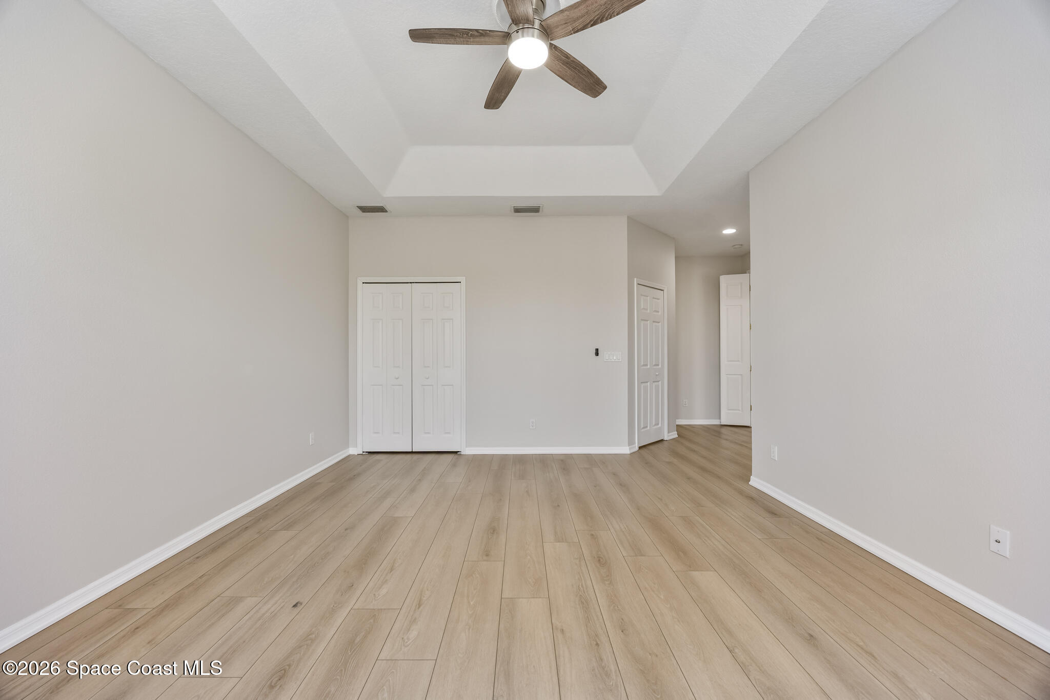 Undisclosed Address Melbourne, FL 32940 - Photo 18 of 26 an empty room with a ceiling fan and wooden floor