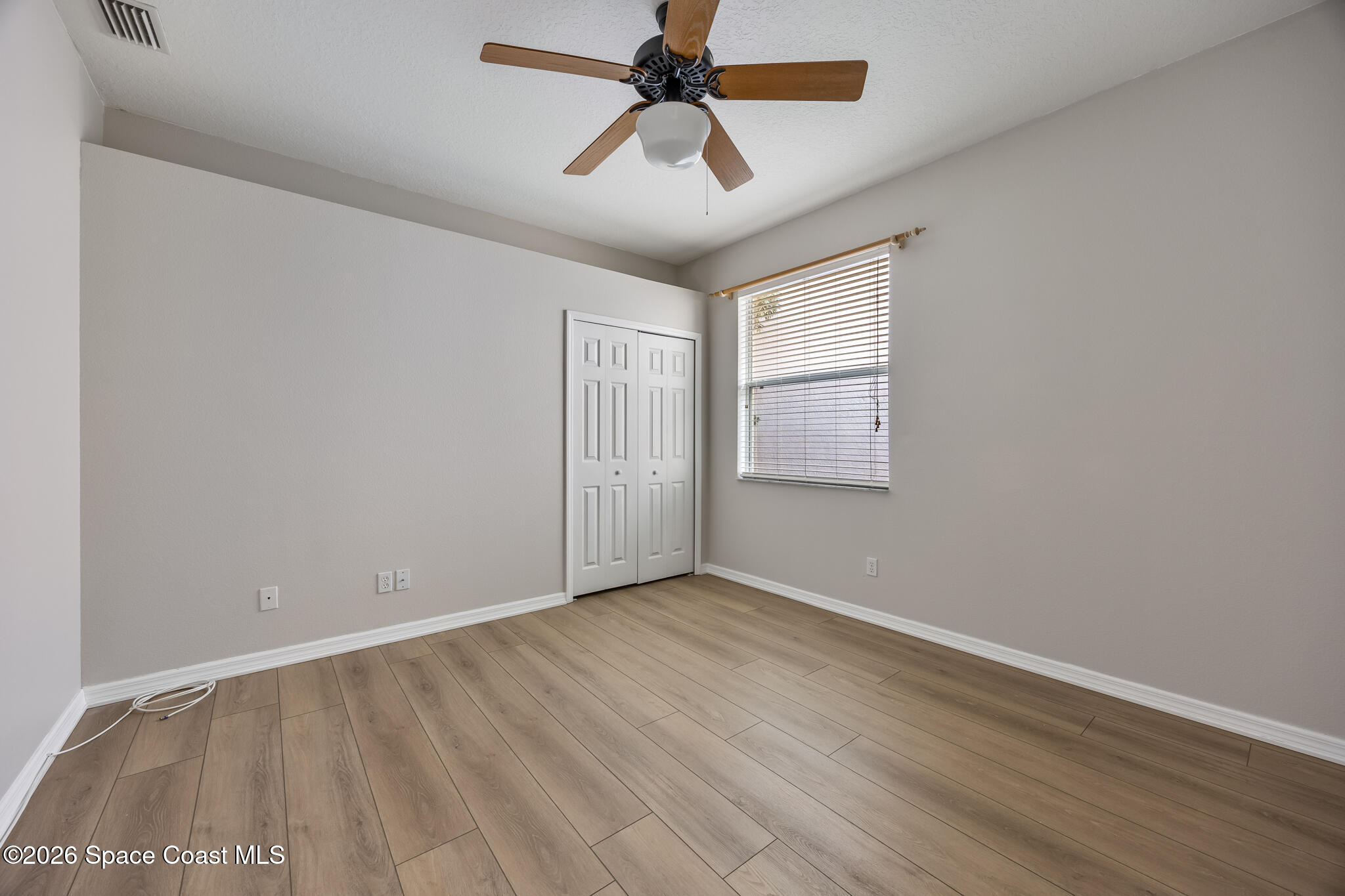 Undisclosed Address Melbourne, FL 32940 - Photo 21 of 26 wooden floor in an empty room with a window