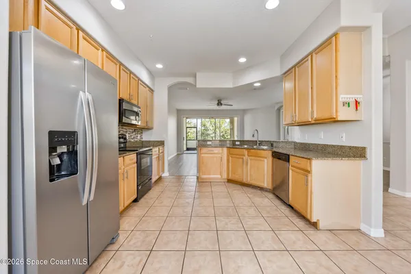 a large kitchen with cabinets and stainless steel appliances