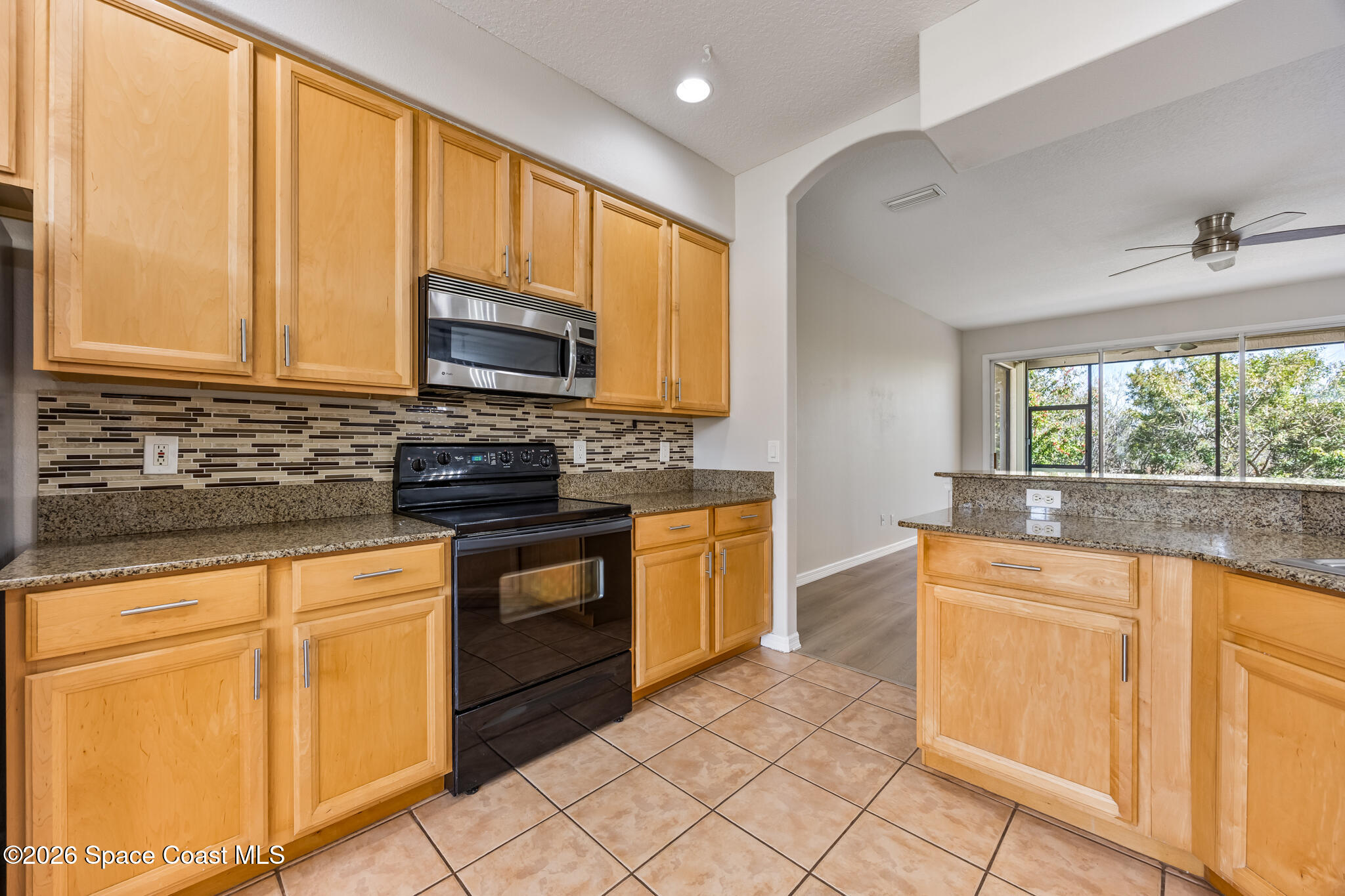Undisclosed Address Melbourne, FL 32940 - Photo 6 of 26 a kitchen with granite countertop cabinets stainless steel appliances a sink and a window