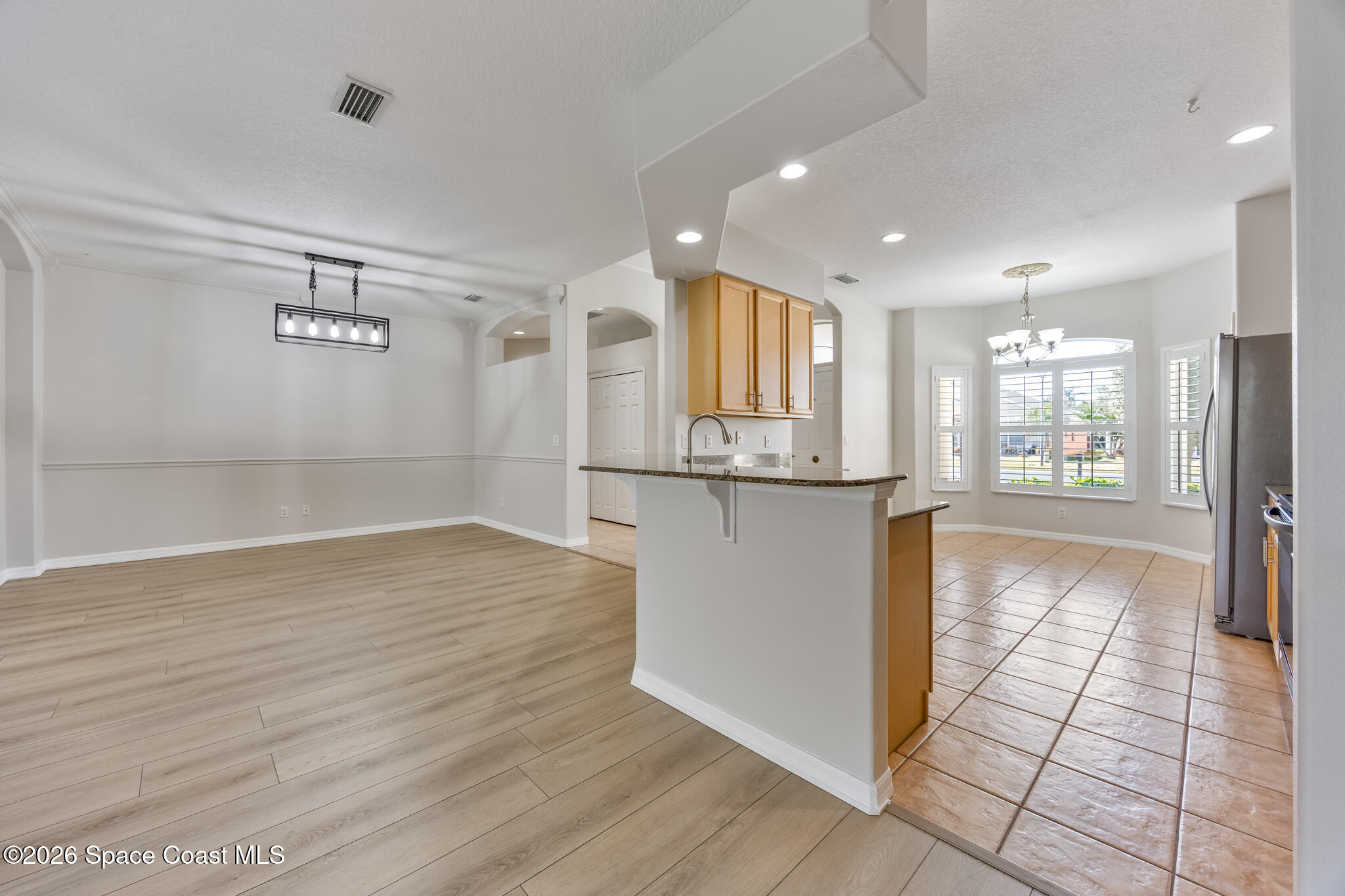 Undisclosed Address Melbourne, FL 32940 - Photo 8 of 26 a view of a refrigerator in kitchen and wooden floor