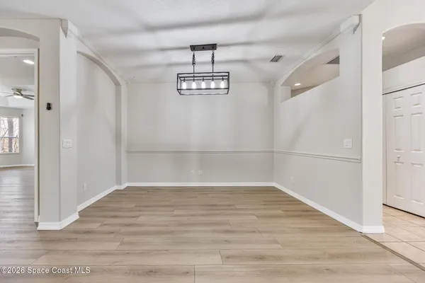 a view of a room with wooden floor