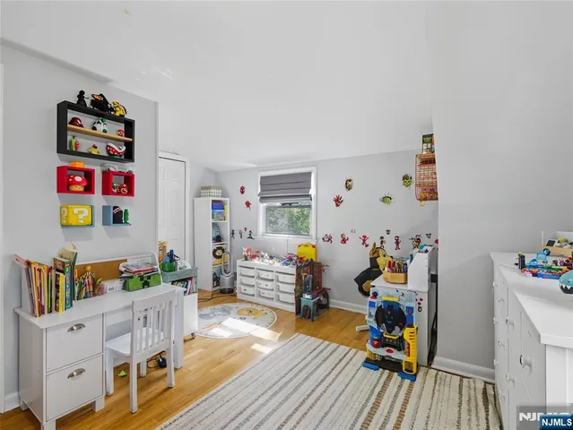 a room with furniture a baby crib and a couch