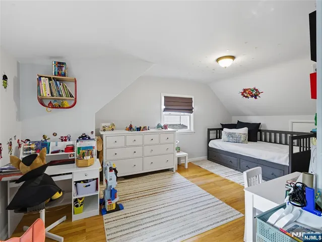 a living room with furniture and paintings on the wall