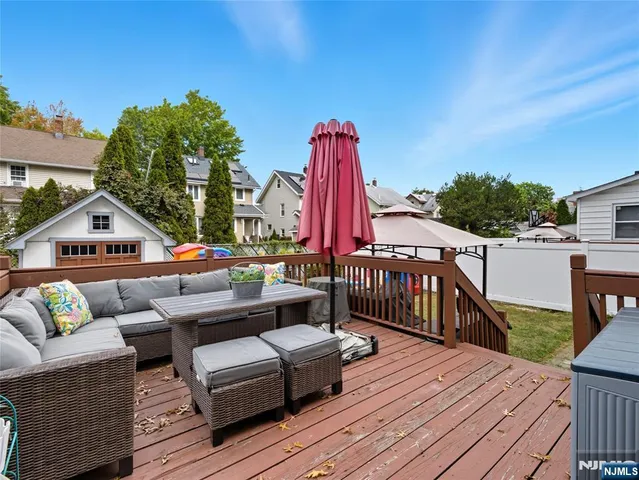 a balcony with furniture and a wooden floor