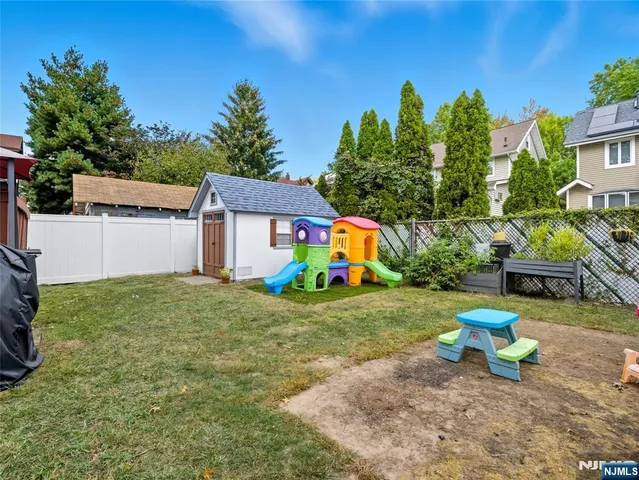 a view of a house with a backyard and sitting area