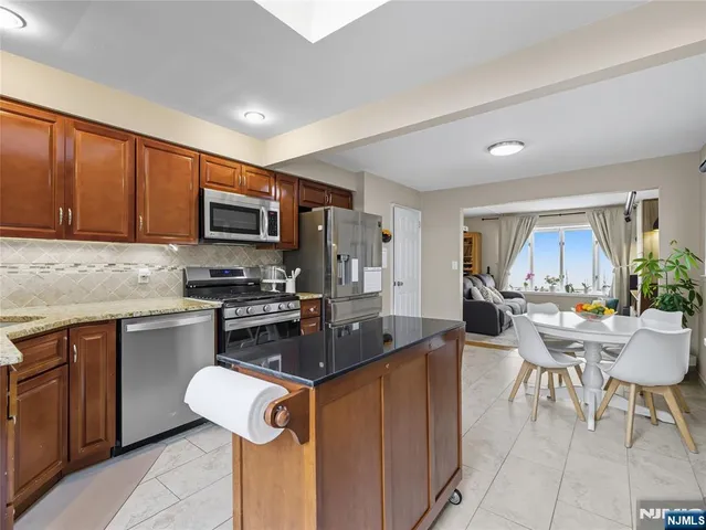 a kitchen with sink a microwave and cabinets