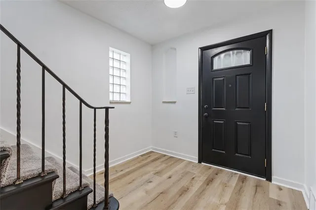 a view of an entryway with wooden floor