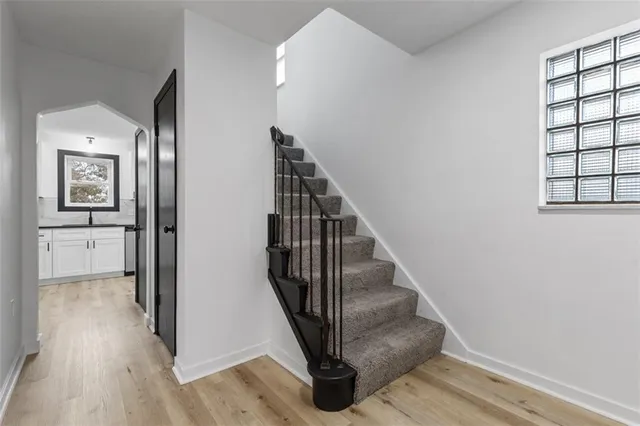 a view of entryway and hall with wooden floor