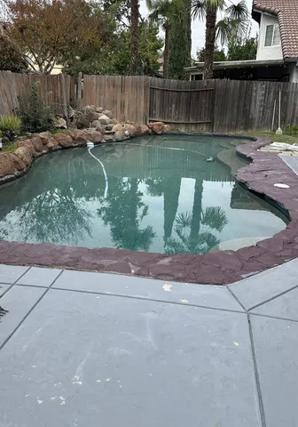 a view of swimming pool with a patio