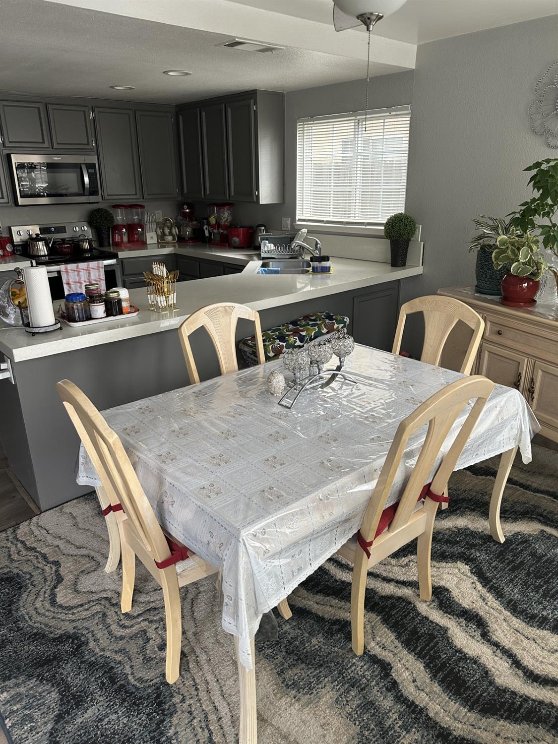 5723 Larcom Lane Stockton, CA 95210 - Photo 6 of 22 a kitchen with a table chairs stove and microwave