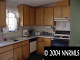 567 Yellow Jacket Road Dayton, NV 89403 - Photo 5 of 6 a kitchen with a sink a stove and cabinets