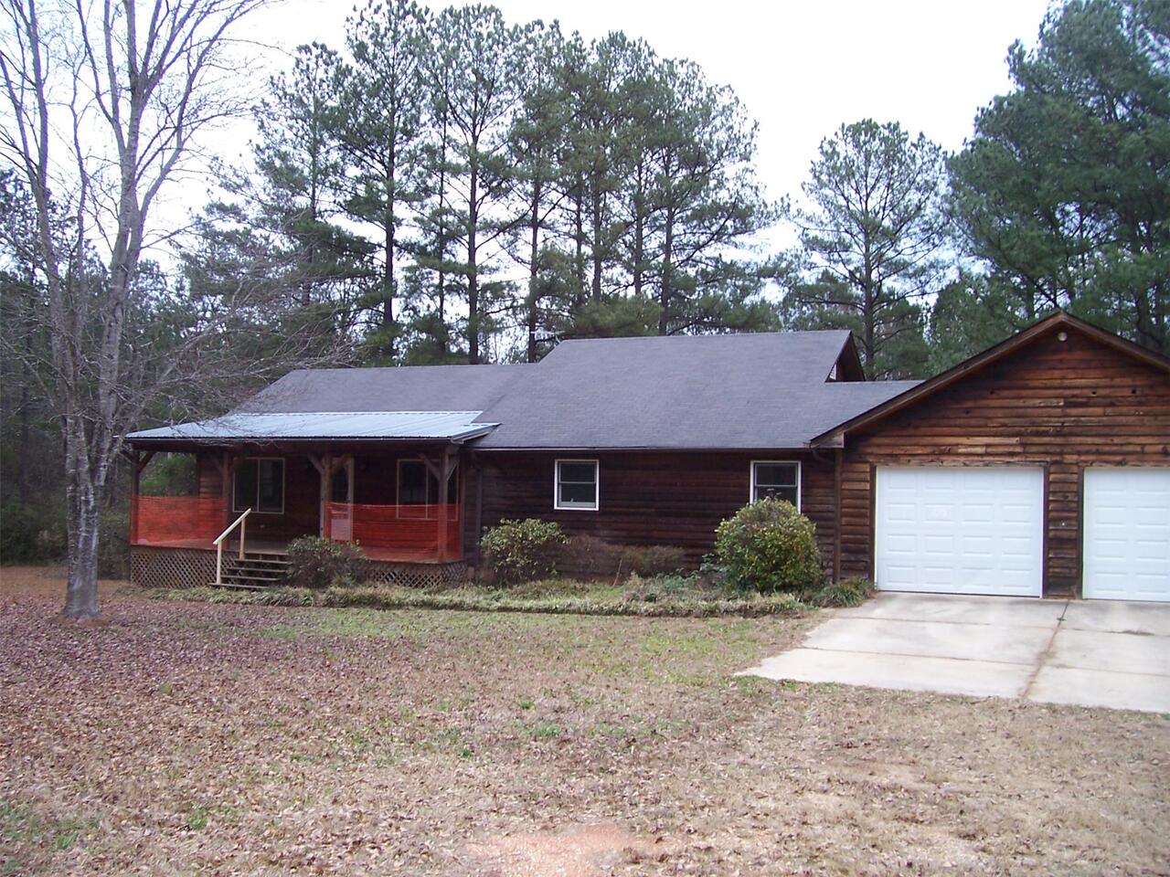 10385 Flat Shoals Road Covington, GA 30014 - Photo 1 of 1 a front view of house with yard and trees around