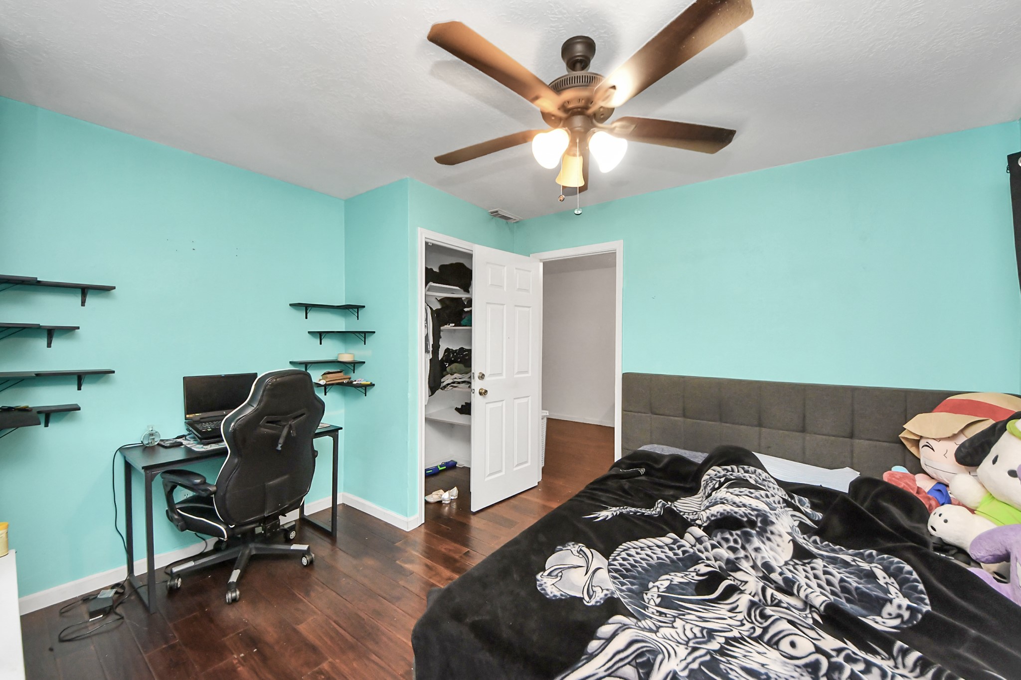 14119 Renn Road Houston, TX 77083 - Photo 13 of 43 a bedroom with a bed and a chandelier