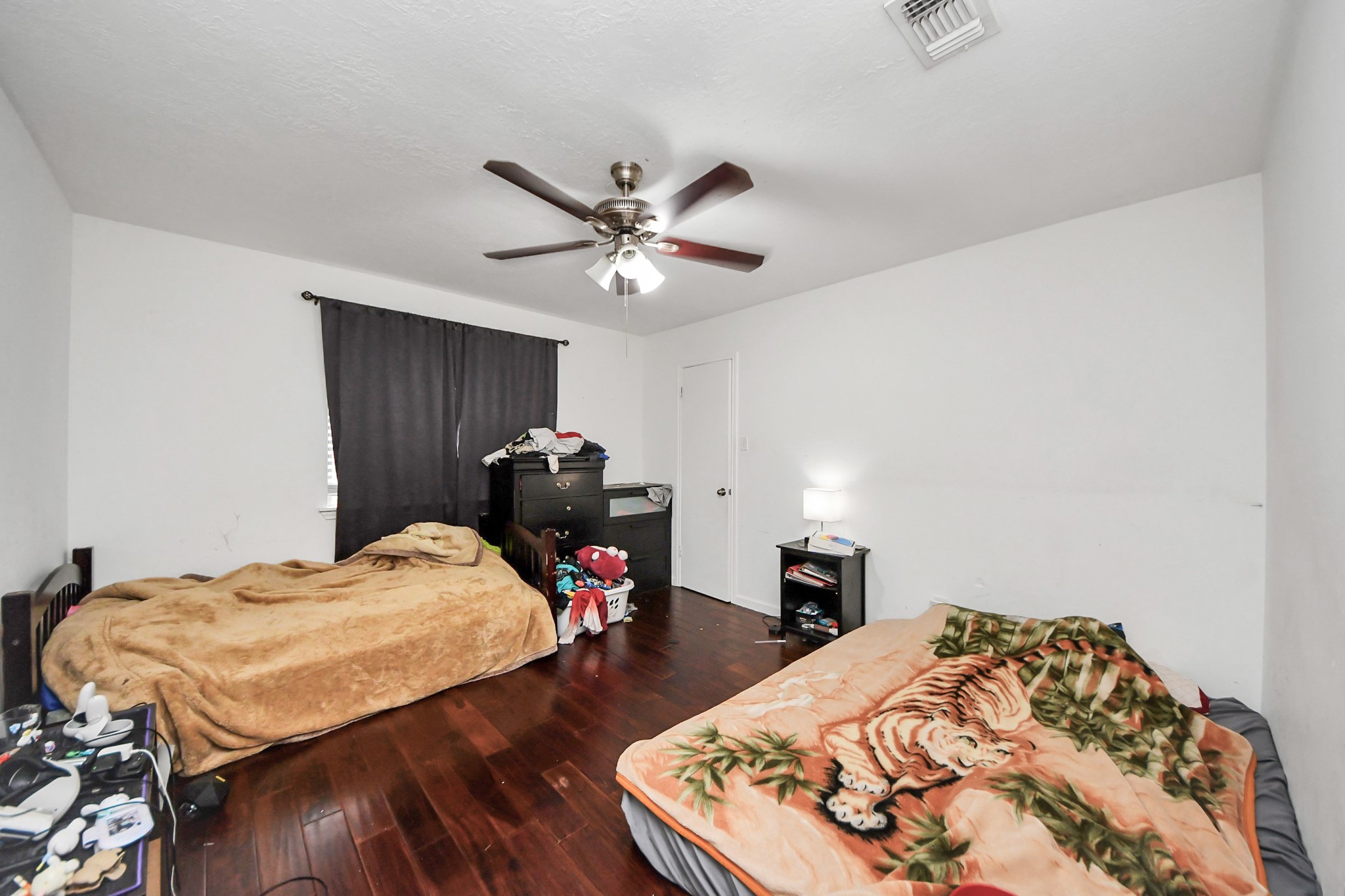 14119 Renn Road Houston, TX 77083 - Photo 22 of 43 a bedroom with a bed and a chandelier