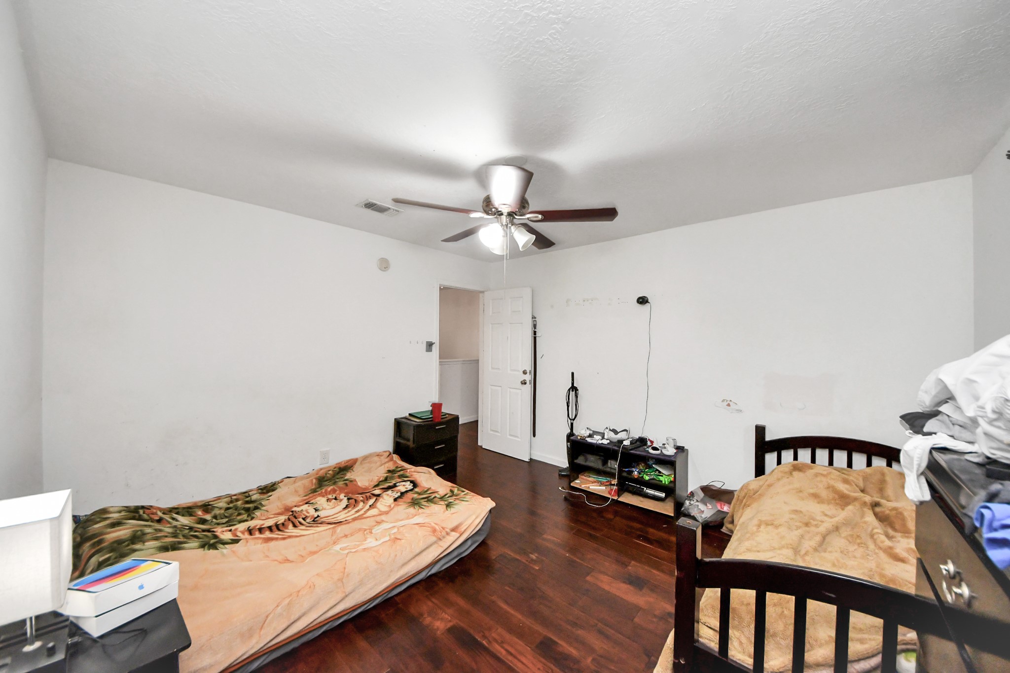 14119 Renn Road Houston, TX 77083 - Photo 23 of 43 a bedroom with furniture and a wooden floor