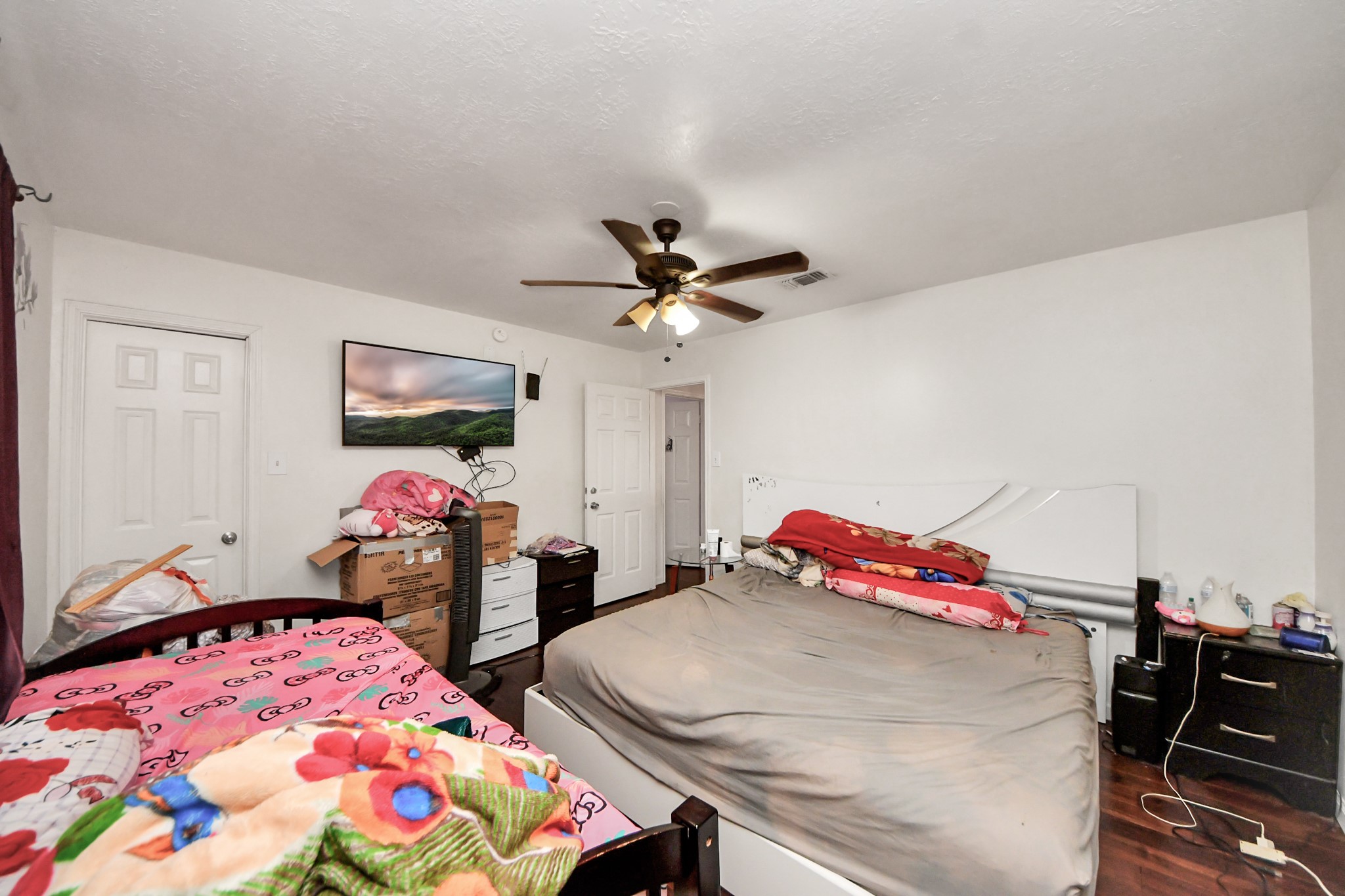 14119 Renn Road Houston, TX 77083 - Photo 28 of 43 a bedroom with bed and two tables