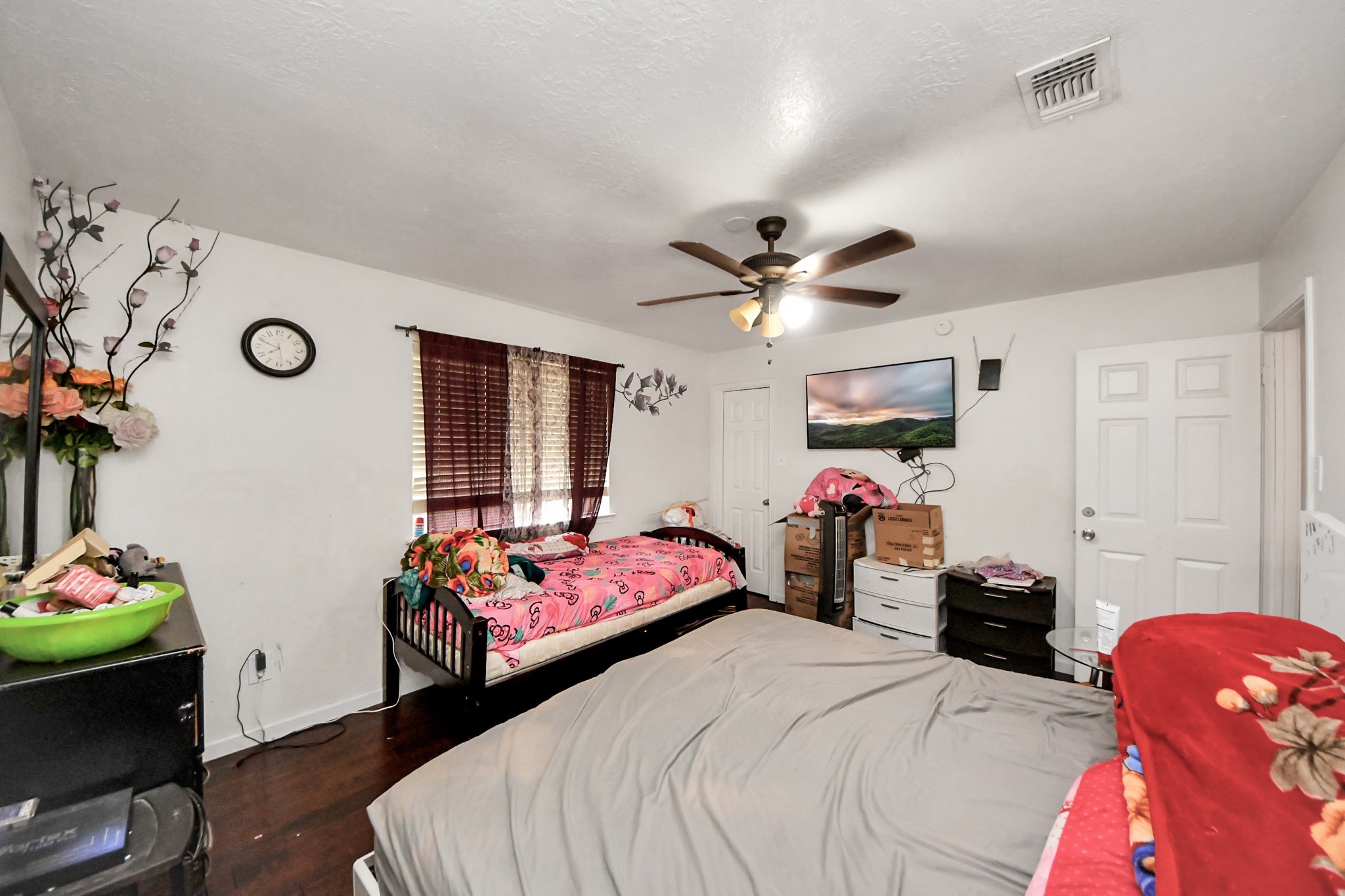 14119 Renn Road Houston, TX 77083 - Photo 29 of 43 a bedroom with a bed and a chandelier