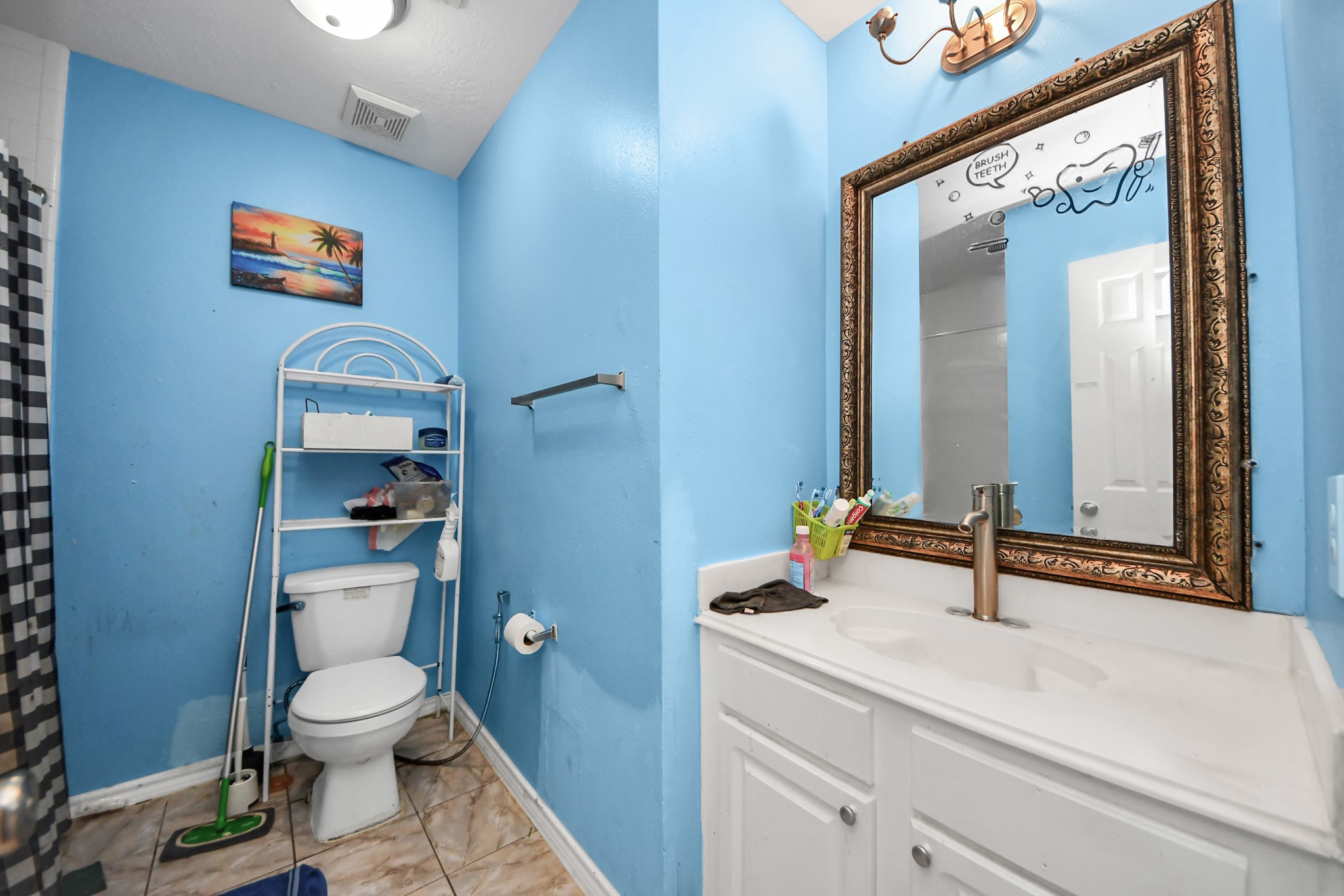 14119 Renn Road Houston, TX 77083 - Photo 30 of 43 a bathroom with a toilet a sink and mirror