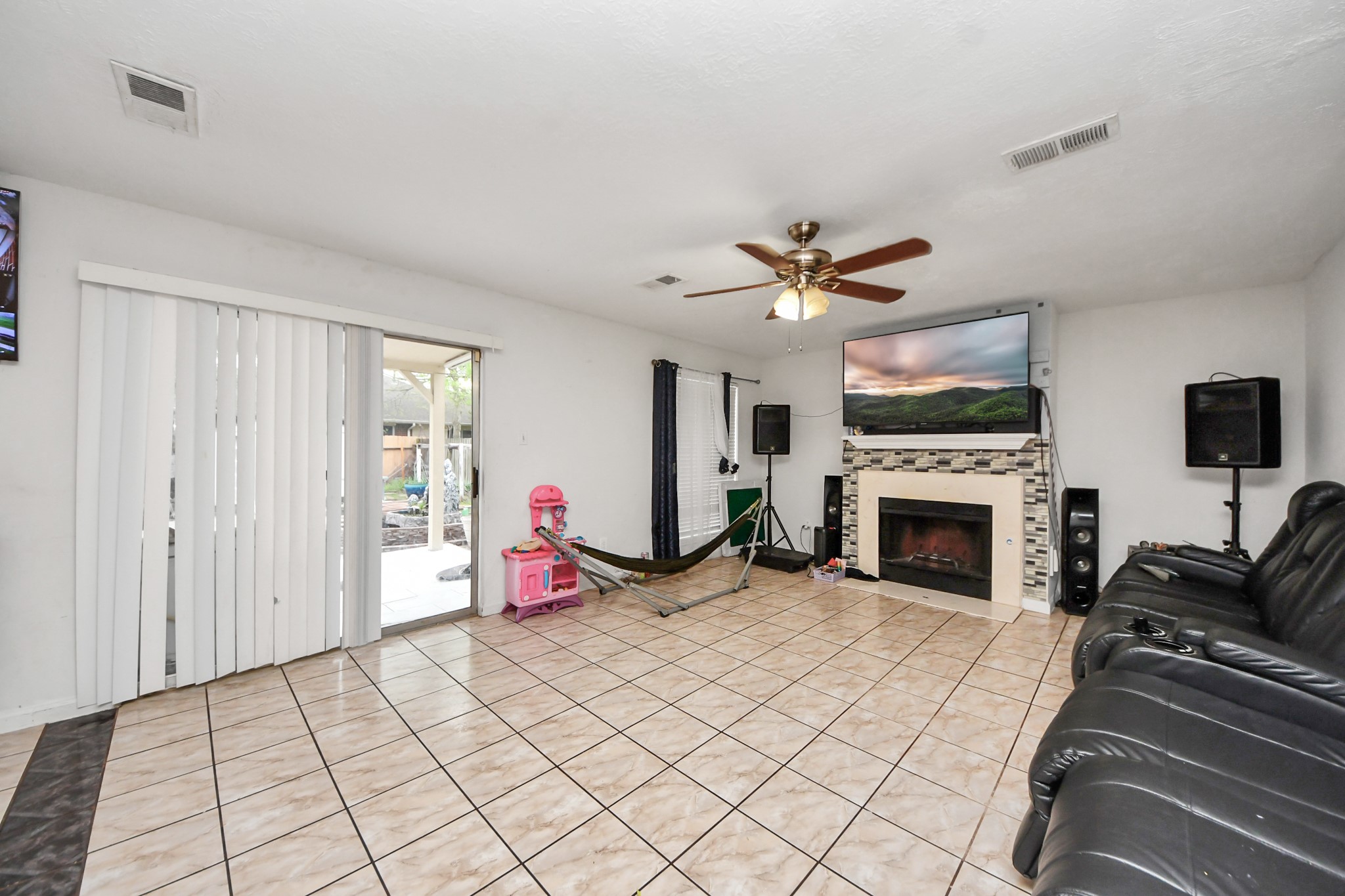 14119 Renn Road Houston, TX 77083 - Photo 3 of 43 a living room with furniture a flat screen tv and a fireplace