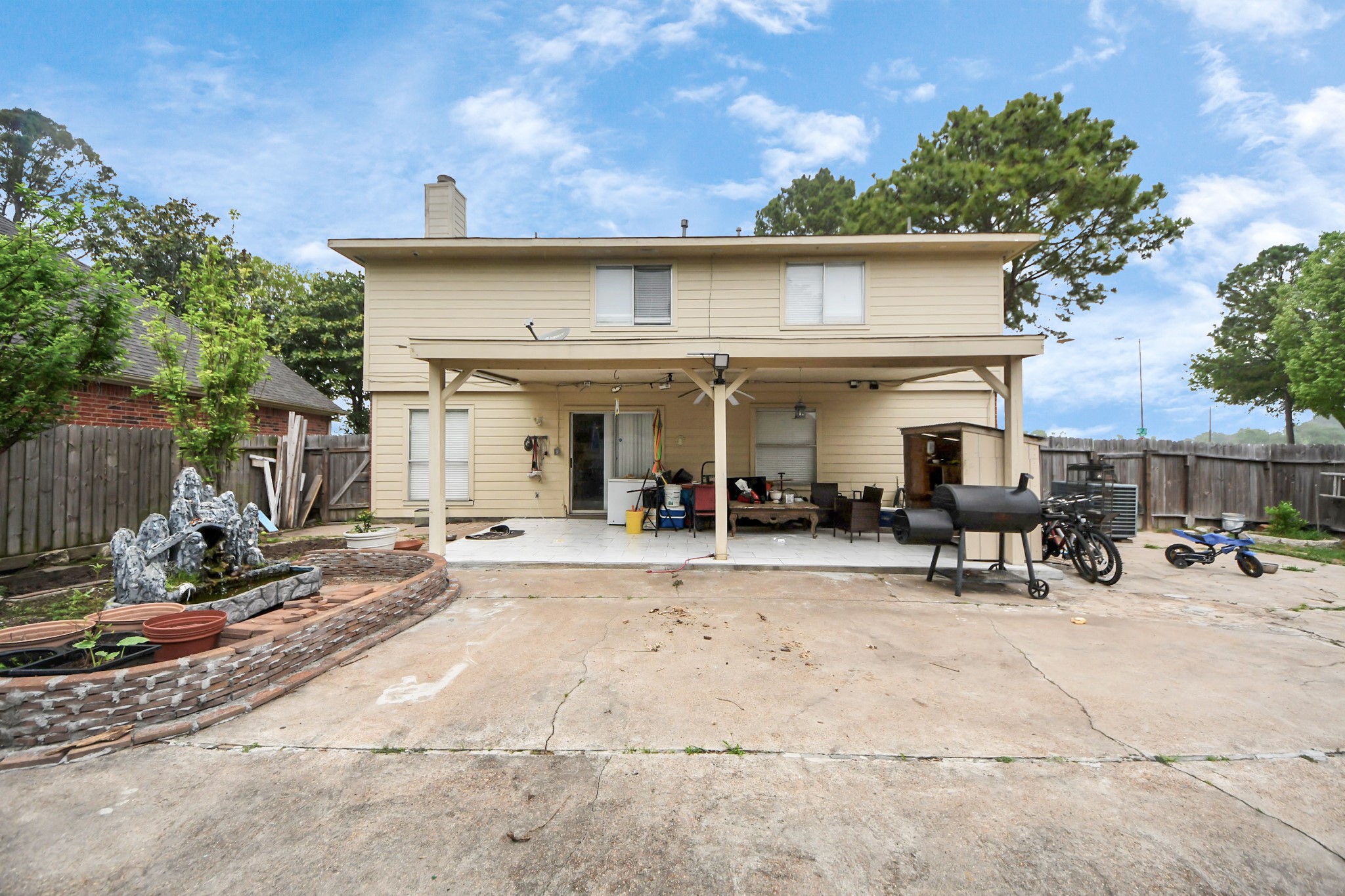14119 Renn Road Houston, TX 77083 - Photo 34 of 43 a view of a house with backyard outdoor seating area and furniture