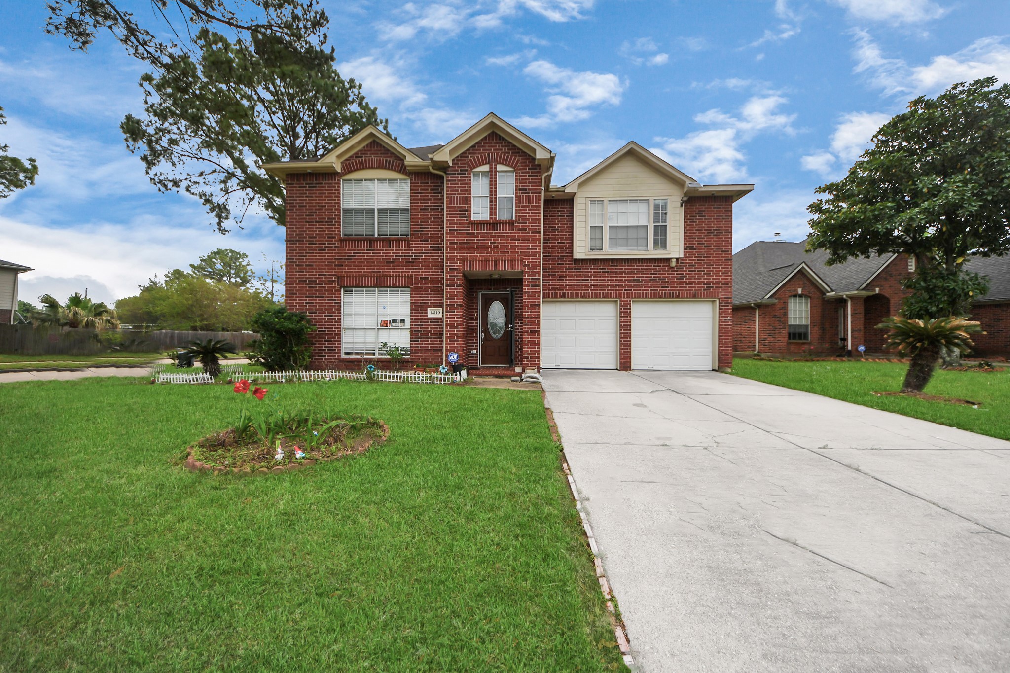 14119 Renn Road Houston, TX 77083 - Photo 37 of 43 a front view of a house with a yard and garage